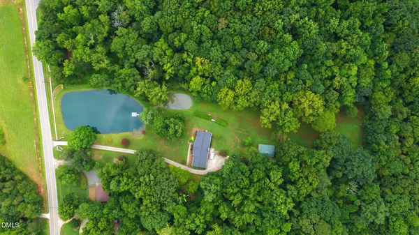 a view of yard with swimming pool and green space