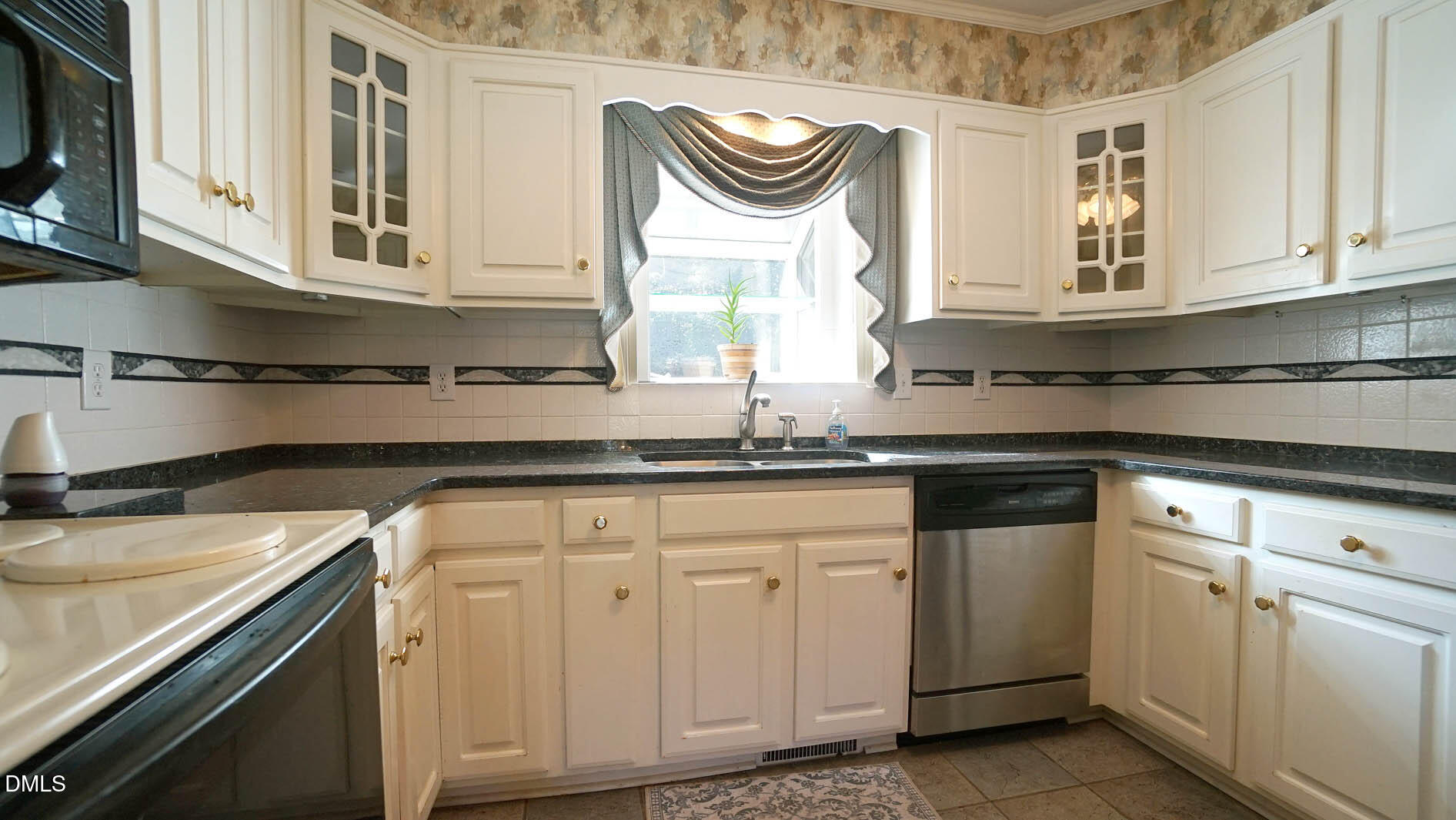 8509 Stagville Road Bahama, NC 27503 - Photo 50 of 95 a kitchen with stainless steel appliances granite countertop a sink a stove and cabinets
