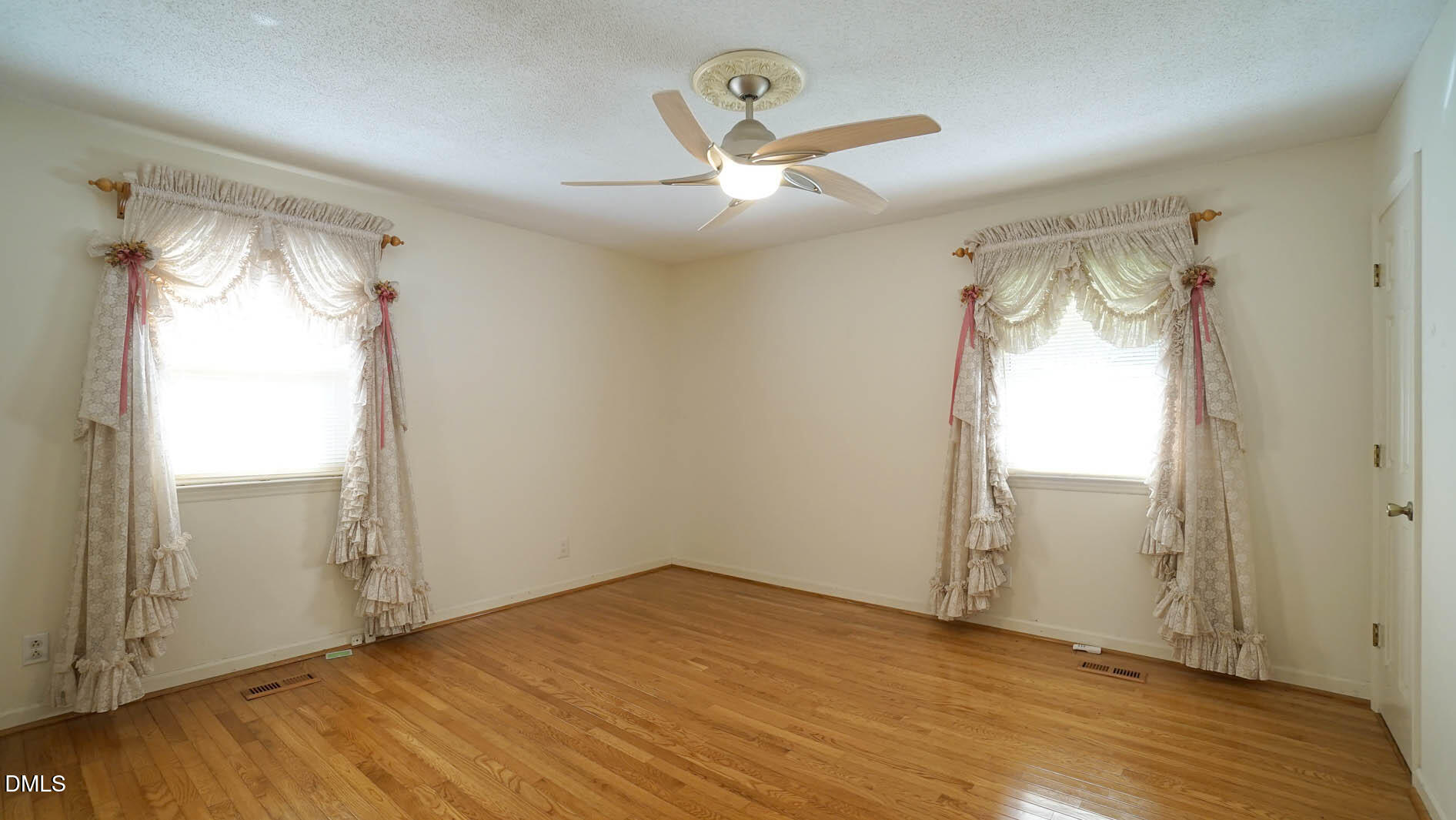 8509 Stagville Road Bahama, NC 27503 - Photo 67 of 95 an empty room with wooden floor fan and windows