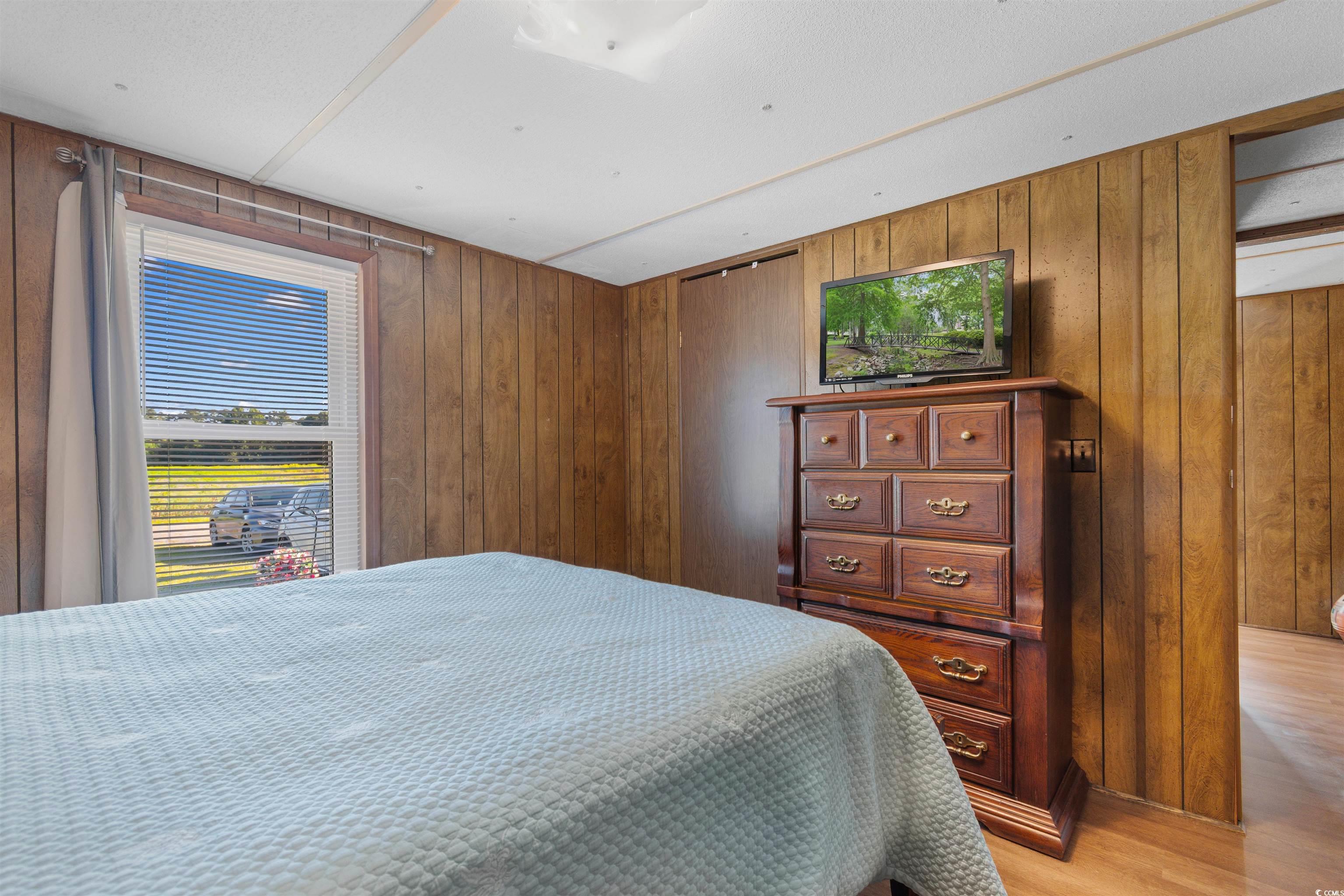 299 Williams Hill Road Hemingway, SC 29554 - Photo 19 of 40 Bedroom with wooden walls and light wood-type flooring