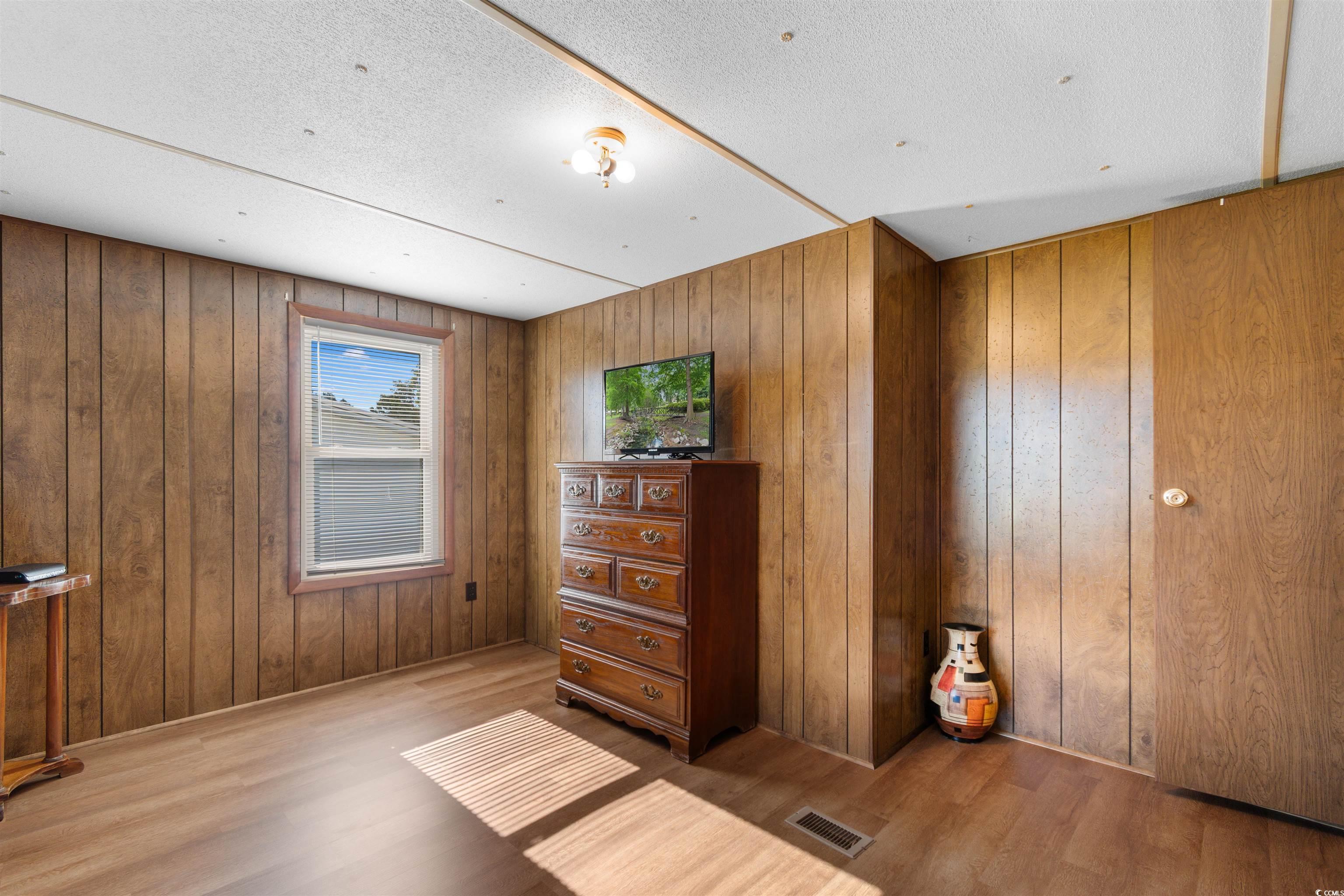 299 Williams Hill Road Hemingway, SC 29554 - Photo 22 of 40 Living area with wood finished floors and a textured ceiling