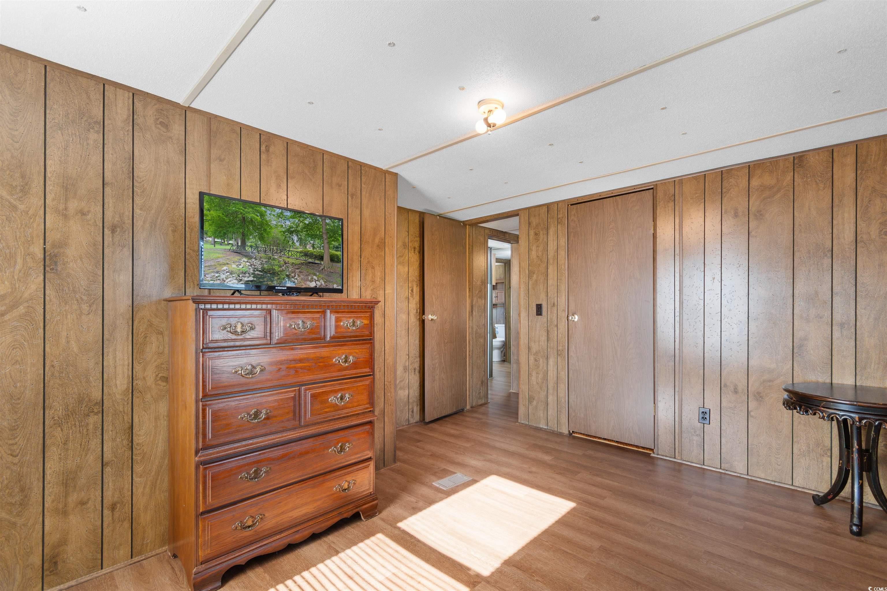 299 Williams Hill Road Hemingway, SC 29554 - Photo 23 of 40 Bedroom featuring light wood-type flooring and wood walls