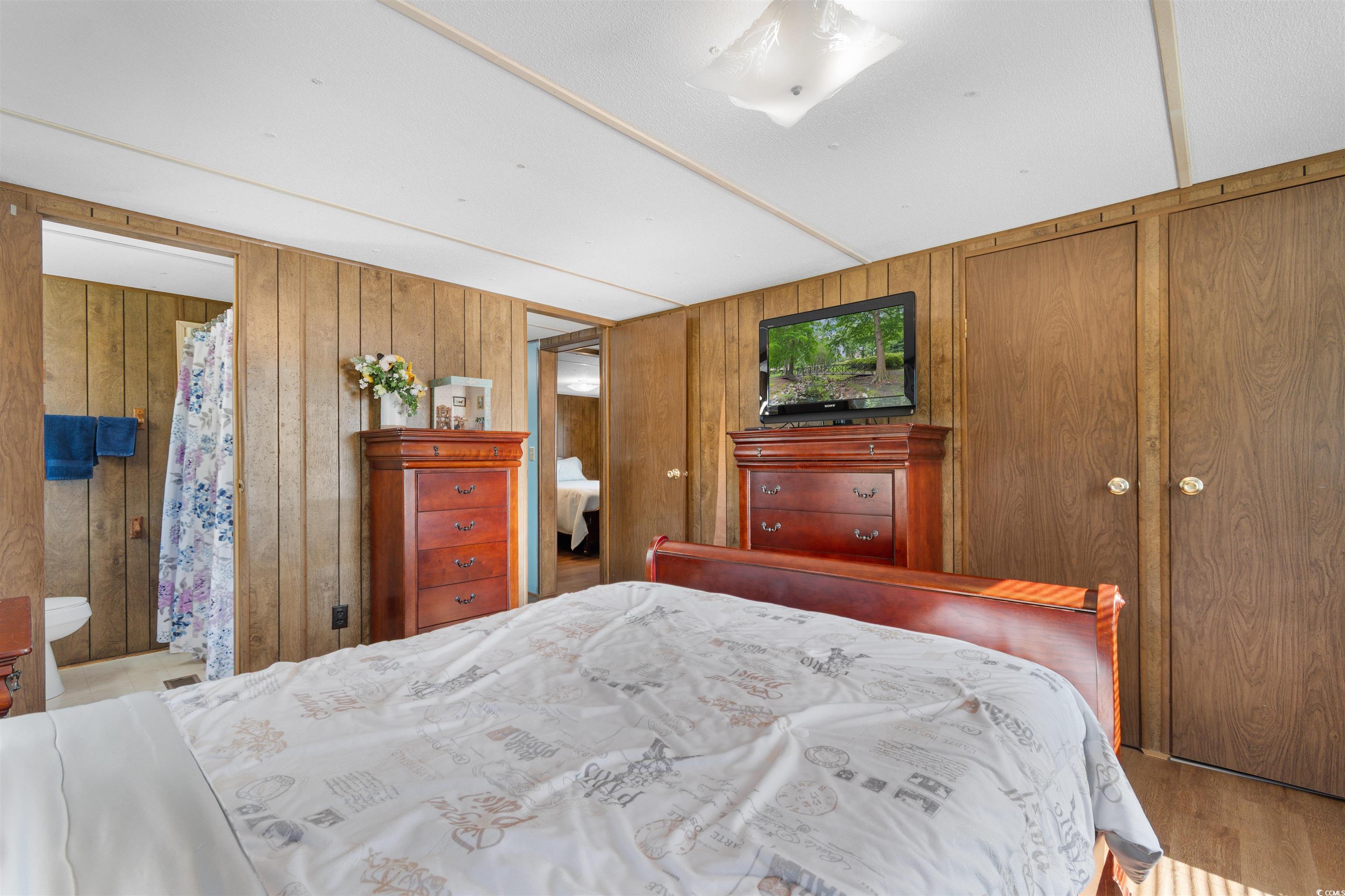 299 Williams Hill Road Hemingway, SC 29554 - Photo 26 of 40 Bedroom featuring wood finished floors and wood walls