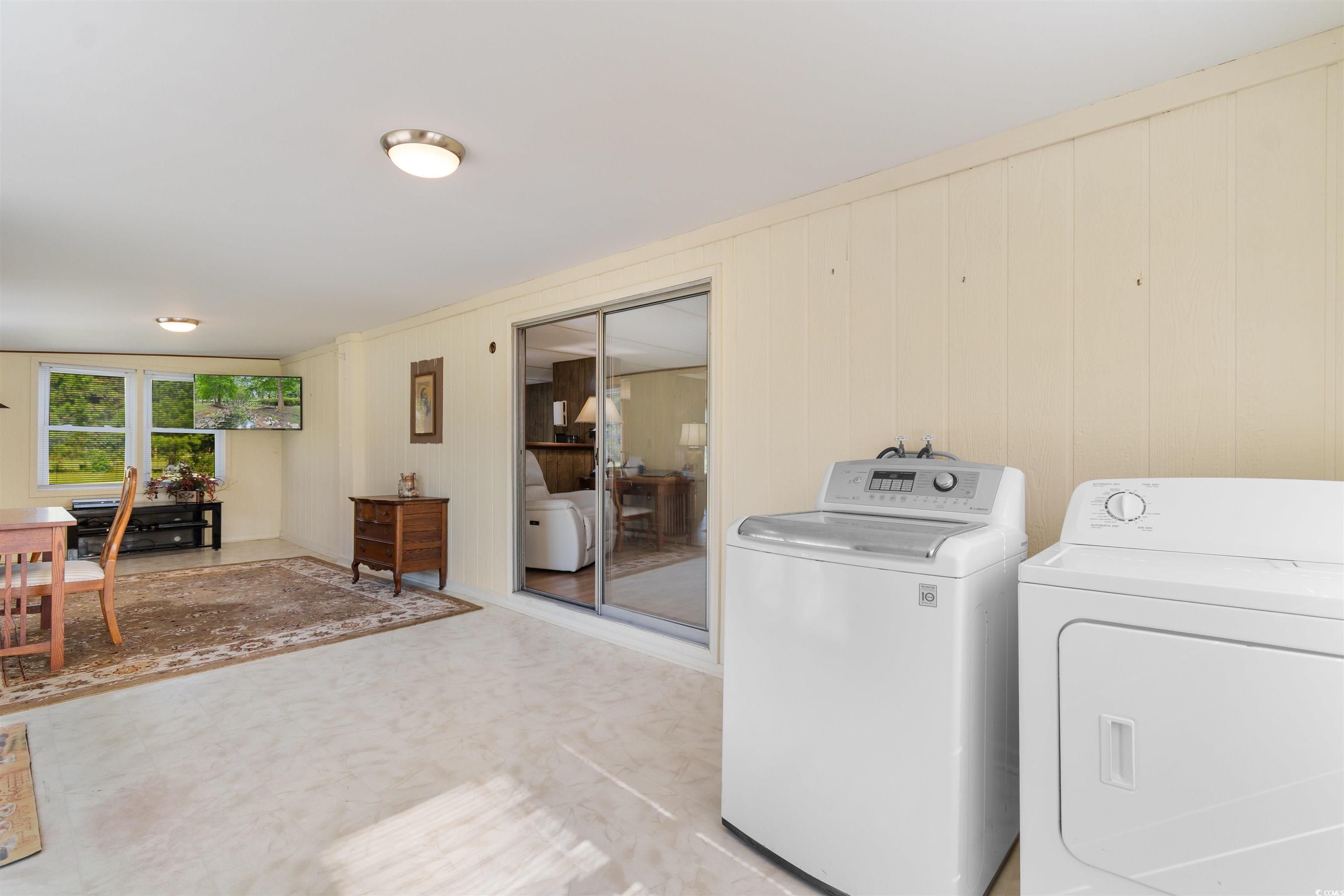 299 Williams Hill Road Hemingway, SC 29554 - Photo 29 of 40 Laundry room featuring separate washer and dryer and wooden walls