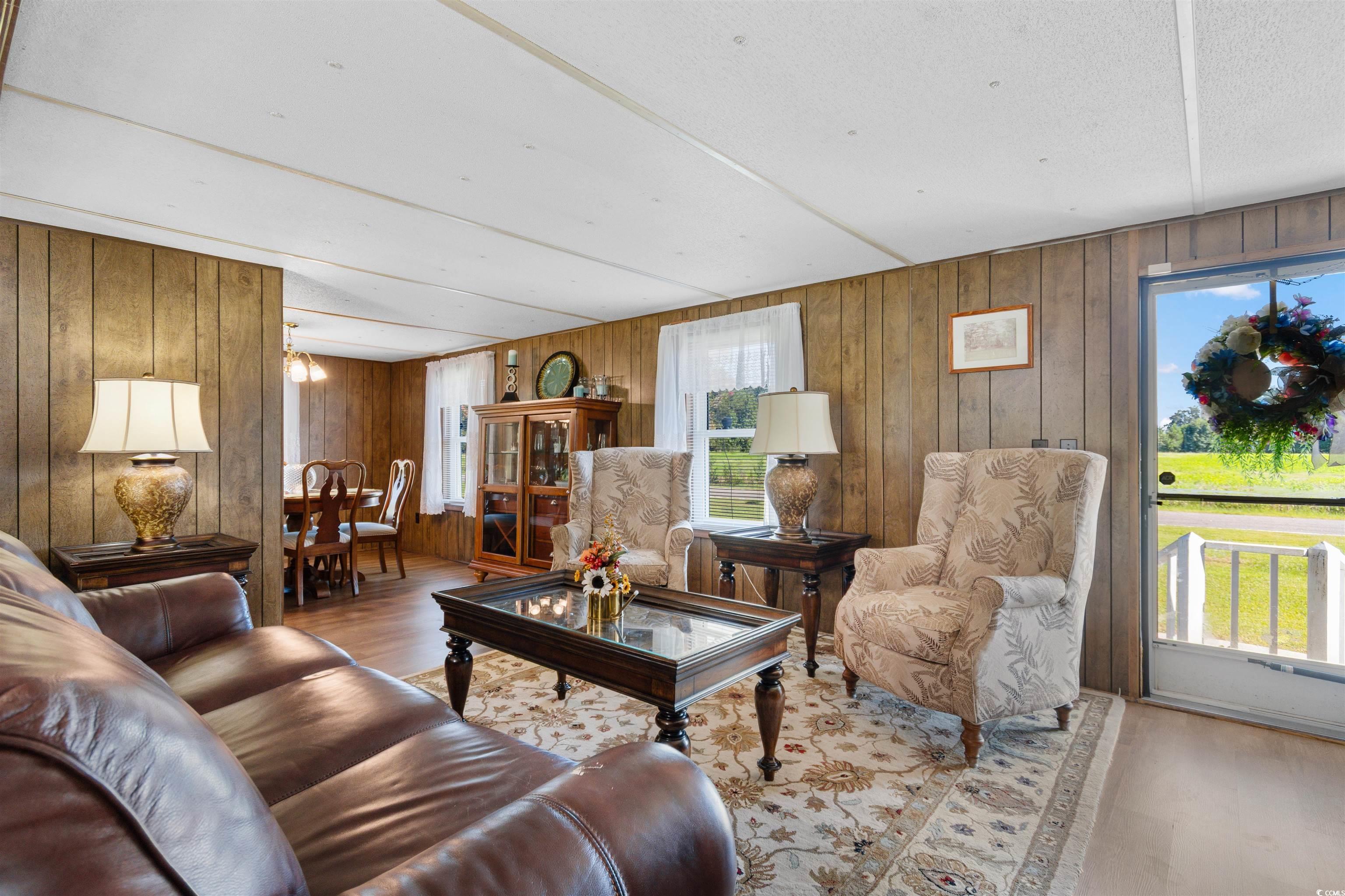 299 Williams Hill Road Hemingway, SC 29554 - Photo 4 of 40 Living room with wood finished floors and wood walls