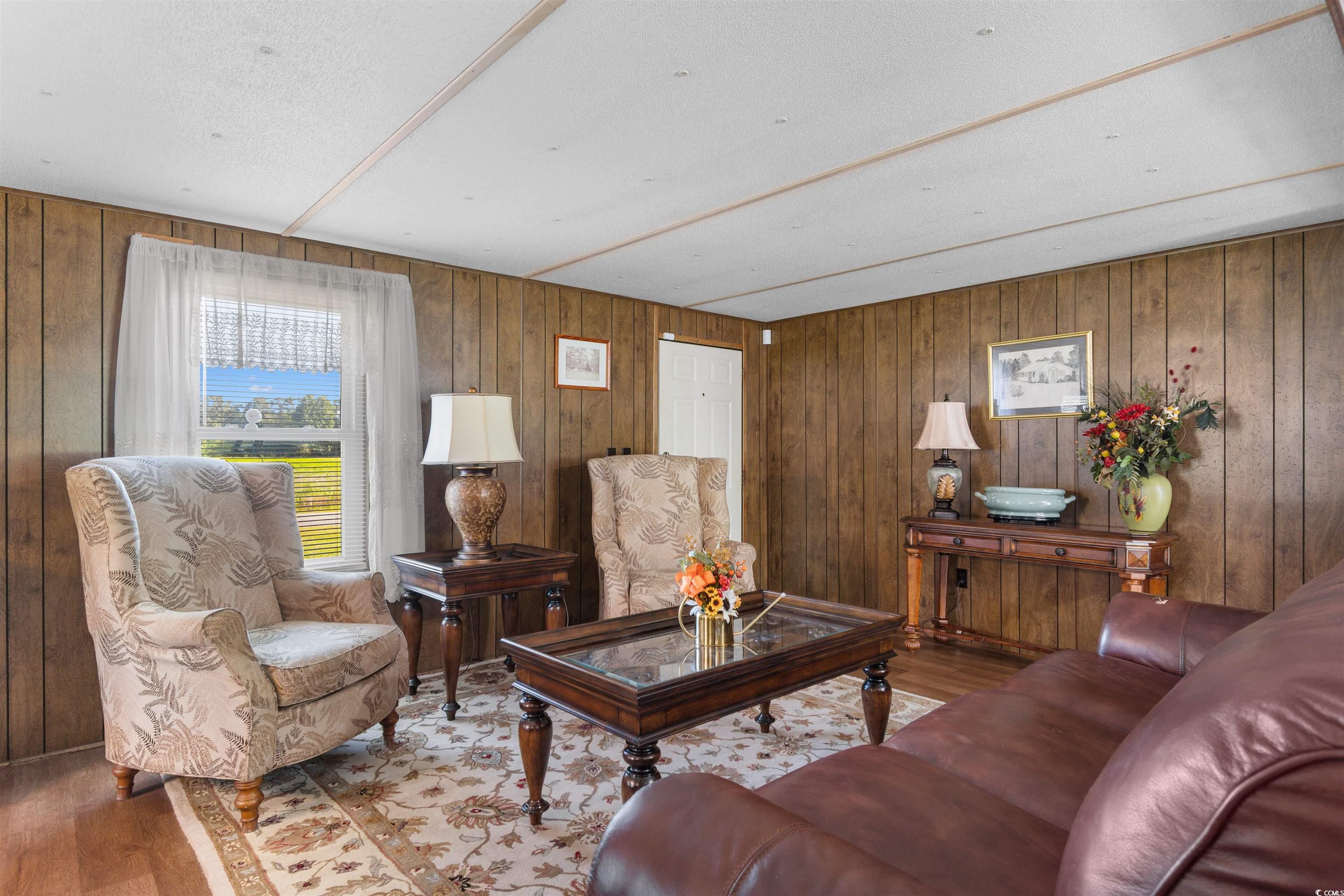 299 Williams Hill Road Hemingway, SC 29554 - Photo 5 of 40 Living room featuring wood finished floors and wooden walls