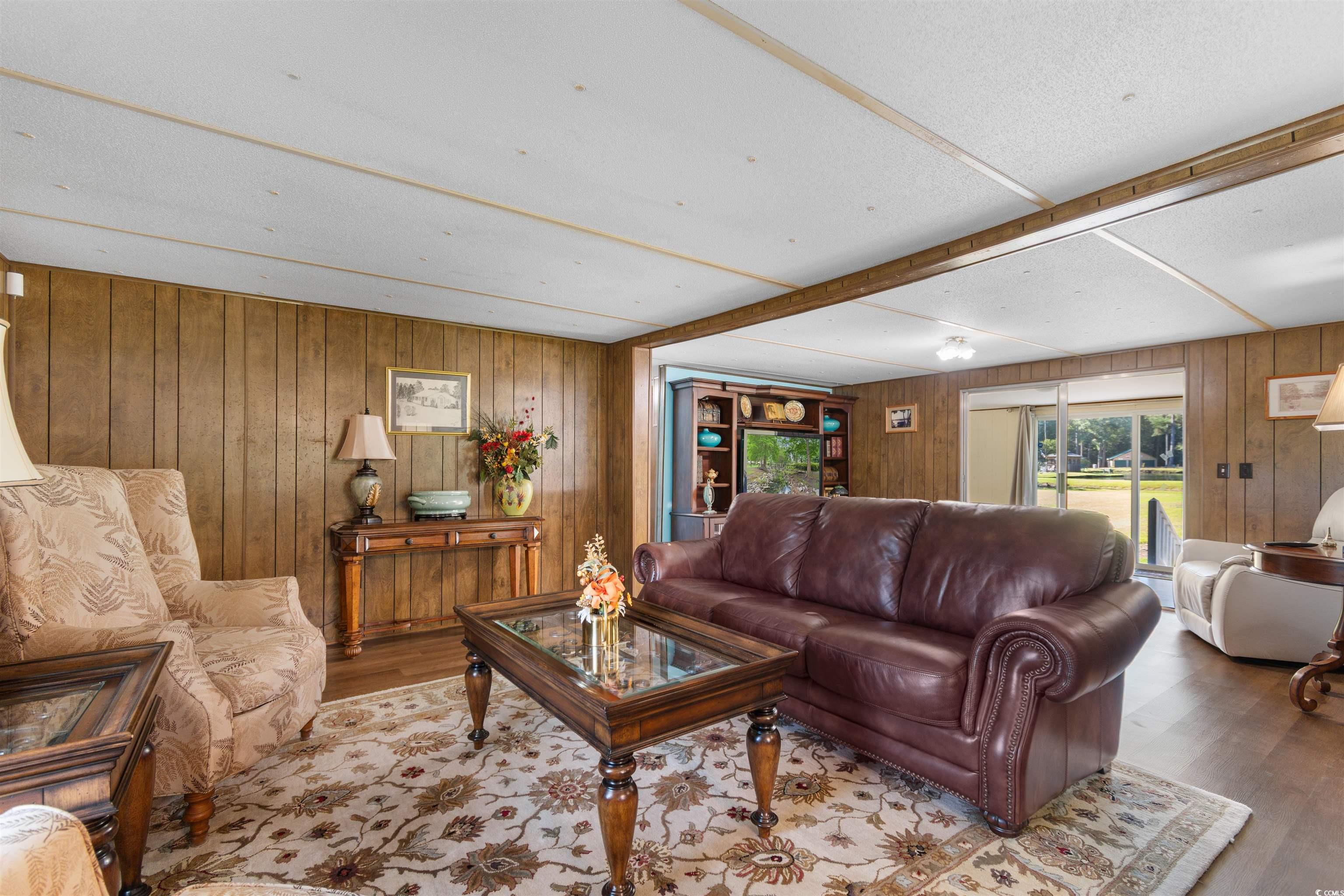 299 Williams Hill Road Hemingway, SC 29554 - Photo 6 of 40 Living area featuring wood walls and wood finished floors