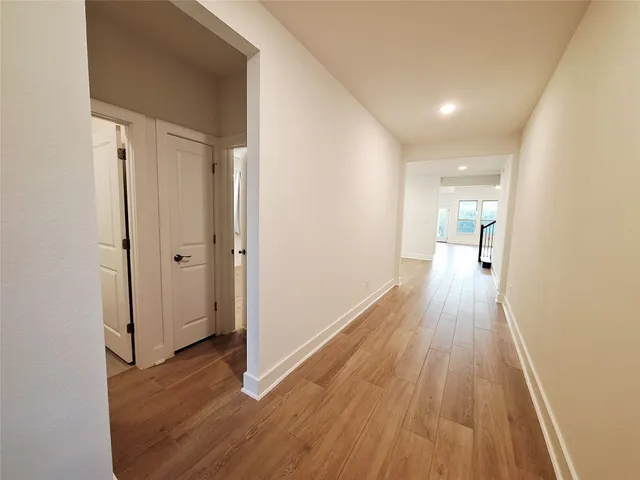 a view of a hallway with wooden floor