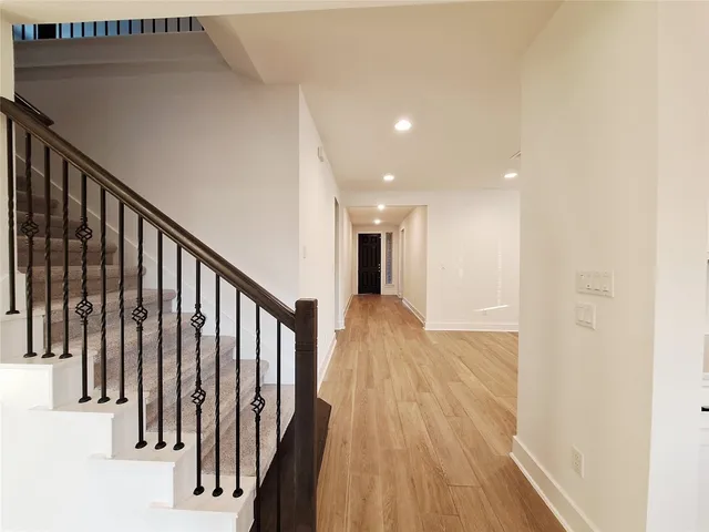 a view of hallway with wooden floor