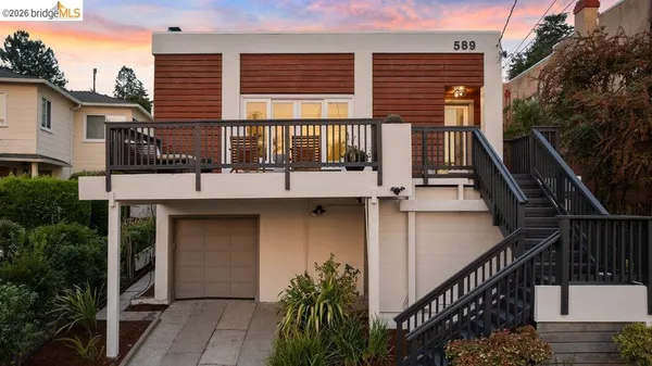 a view of a house with a wooden fence