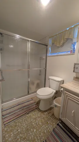 a bathroom with a toilet and a shower