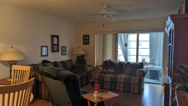 a living room with furniture a wooden floor and a window