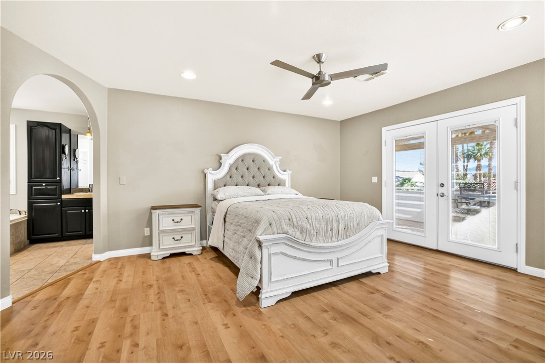 1135 Calico Ridge Drive Henderson, NV 89011 - Photo 31 of 86 Well-lit sleeping quarters with a private balcony entrance and beautiful wood-look flooring.