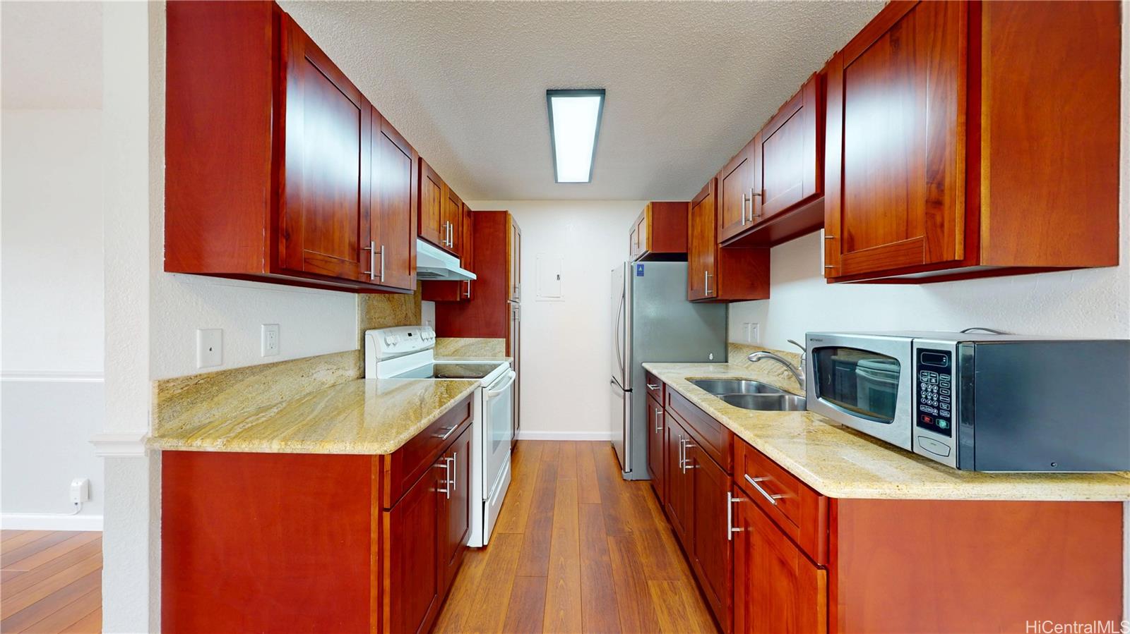 a kitchen with stainless steel appliances granite countertop wooden cabinets a sink and dishwasher