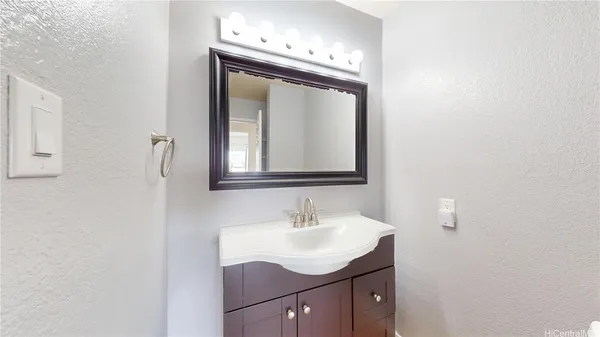 a bathroom with a sink vanity and a mirror