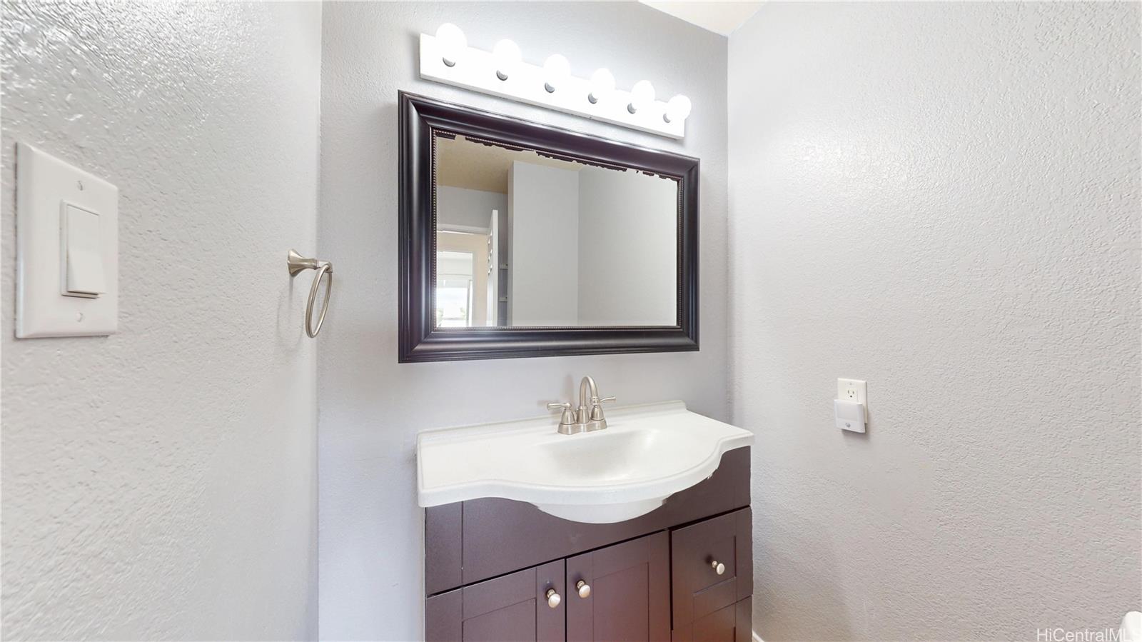 94-1036 Paha Place, Unit R8 Waipahu, HI 96797 - Photo 12 of 23 a bathroom with a sink vanity and a mirror