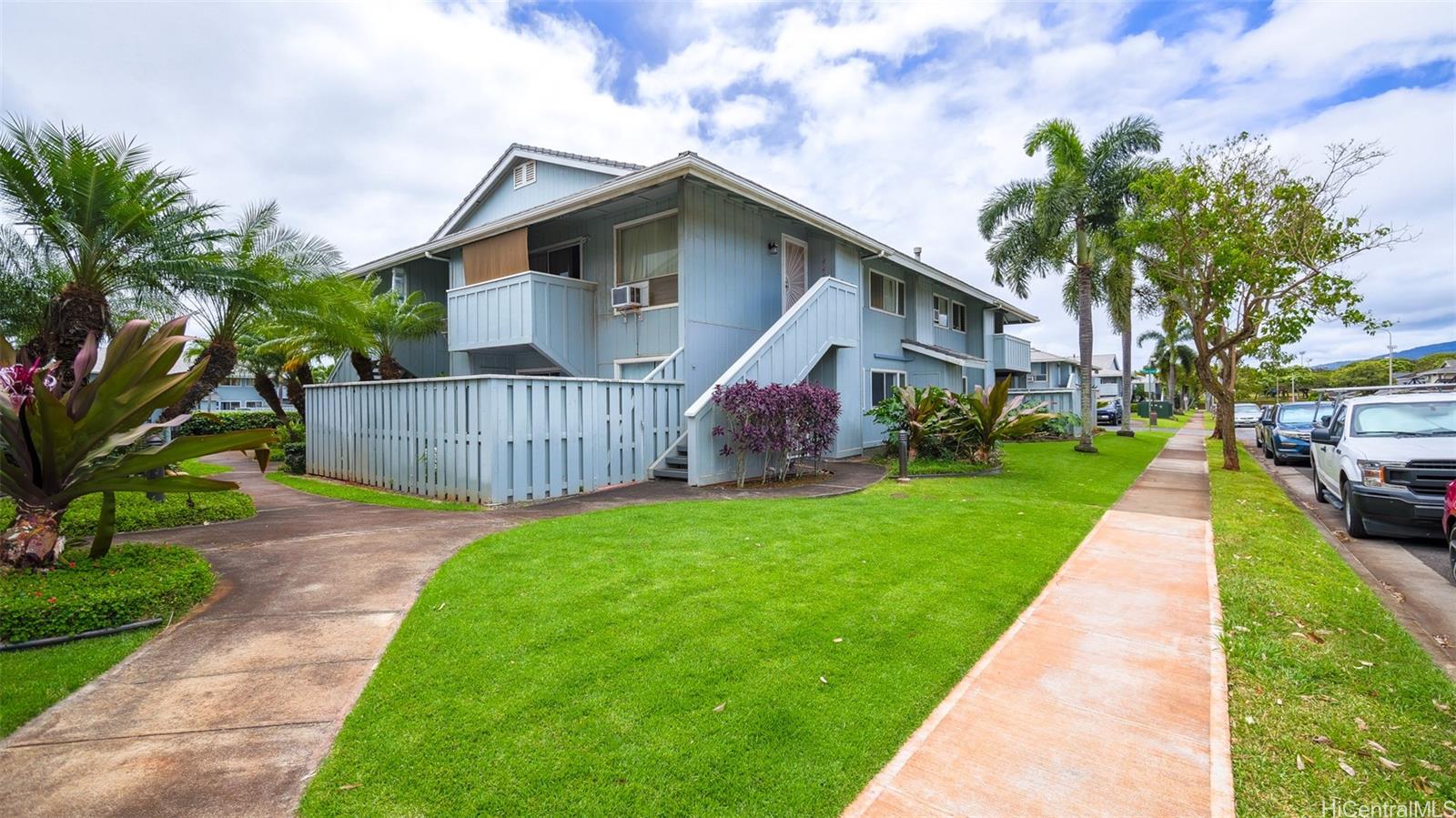 94-1036 Paha Place, Unit R8 Waipahu, HI 96797 - Photo 18 of 23 a front view of house with yard and green space
