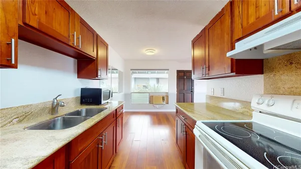 a kitchen with a sink stove and microwave