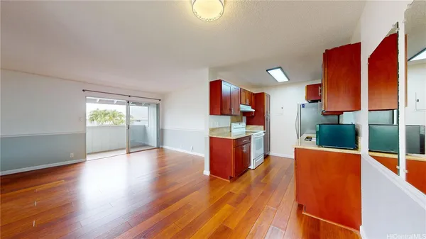a view of kitchen and hall with wooden floor