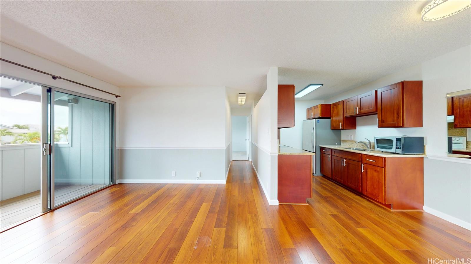 94-1036 Paha Place, Unit R8 Waipahu, HI 96797 - Photo 4 of 23 a kitchen with stainless steel appliances granite countertop a refrigerator and a wooden cabinets