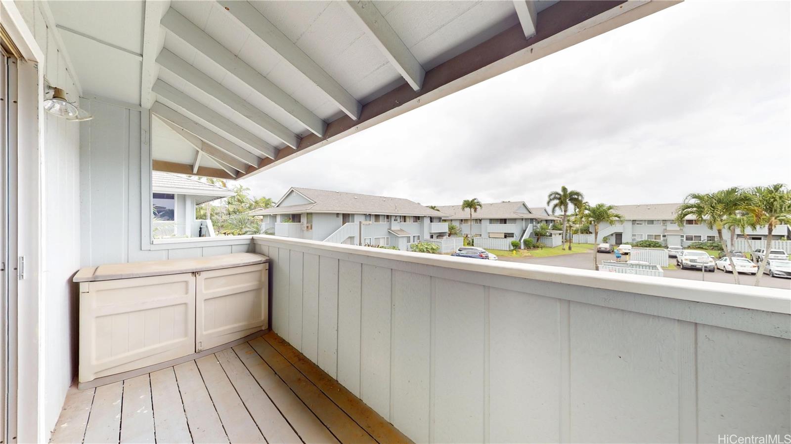 94-1036 Paha Place, Unit R8 Waipahu, HI 96797 - Photo 6 of 23 a kitchen with a sink and wooden floor