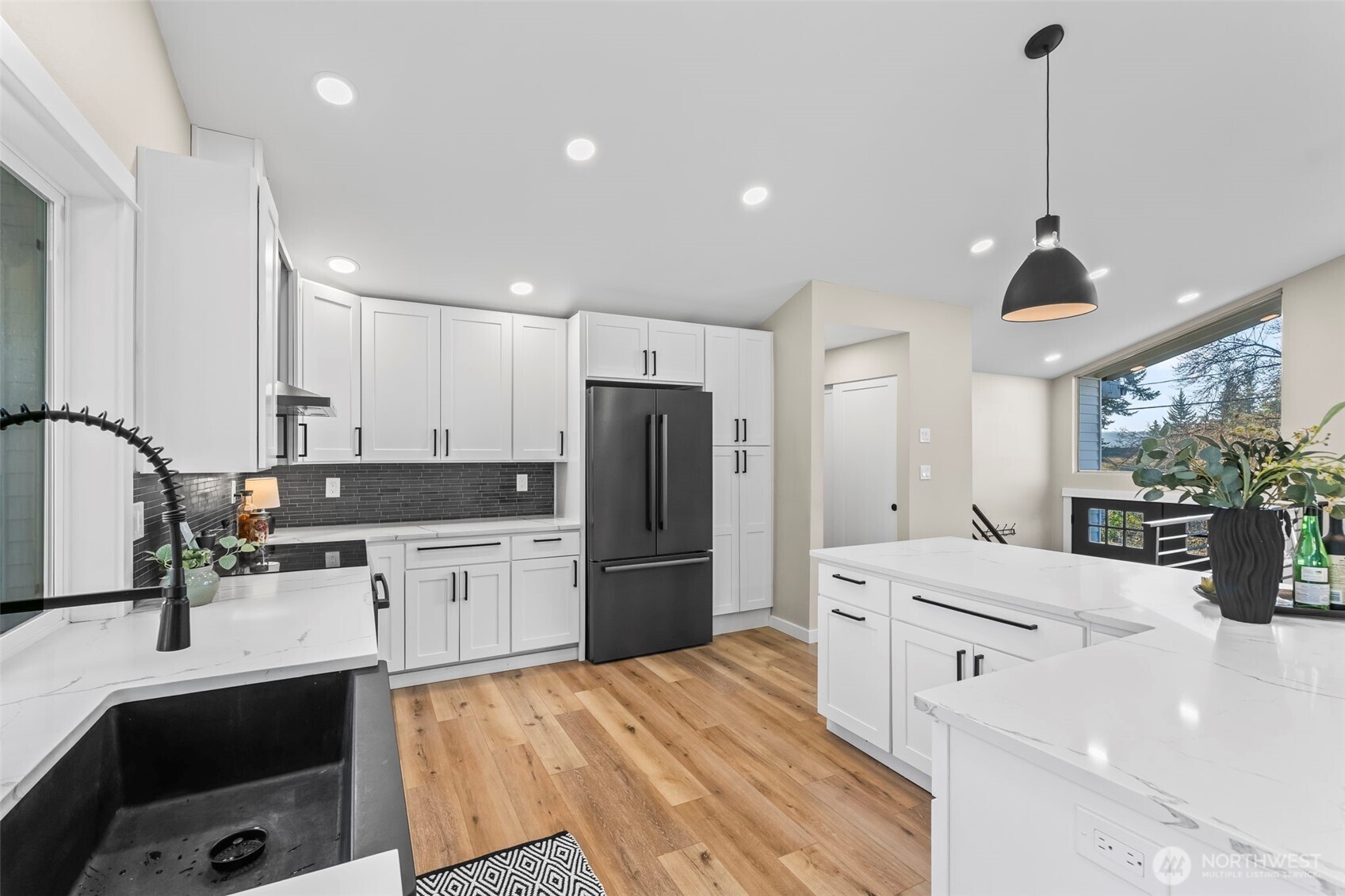 9844 Olson Road Northwest Silverdale, WA 98383 - Photo 13 of 38 a large kitchen with kitchen island a sink stainless steel appliances and cabinets