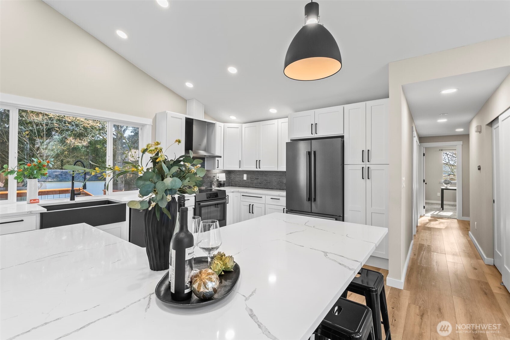 9844 Olson Road Northwest Silverdale, WA 98383 - Photo 17 of 38 a kitchen with a refrigerator and a wooden floor