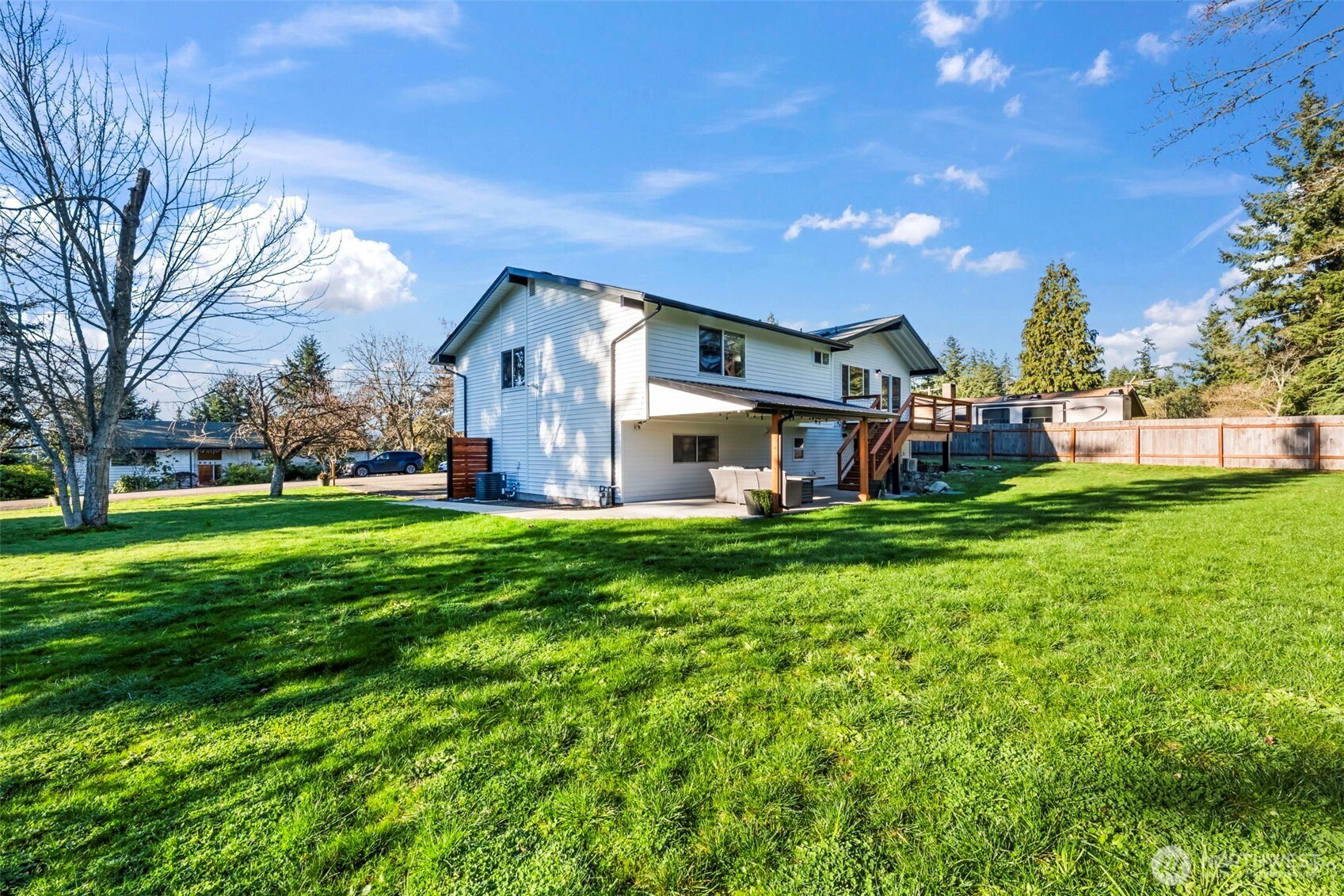 9844 Olson Road Northwest Silverdale, WA 98383 - Photo 35 of 38 a front view of a house with a yard table and chairs