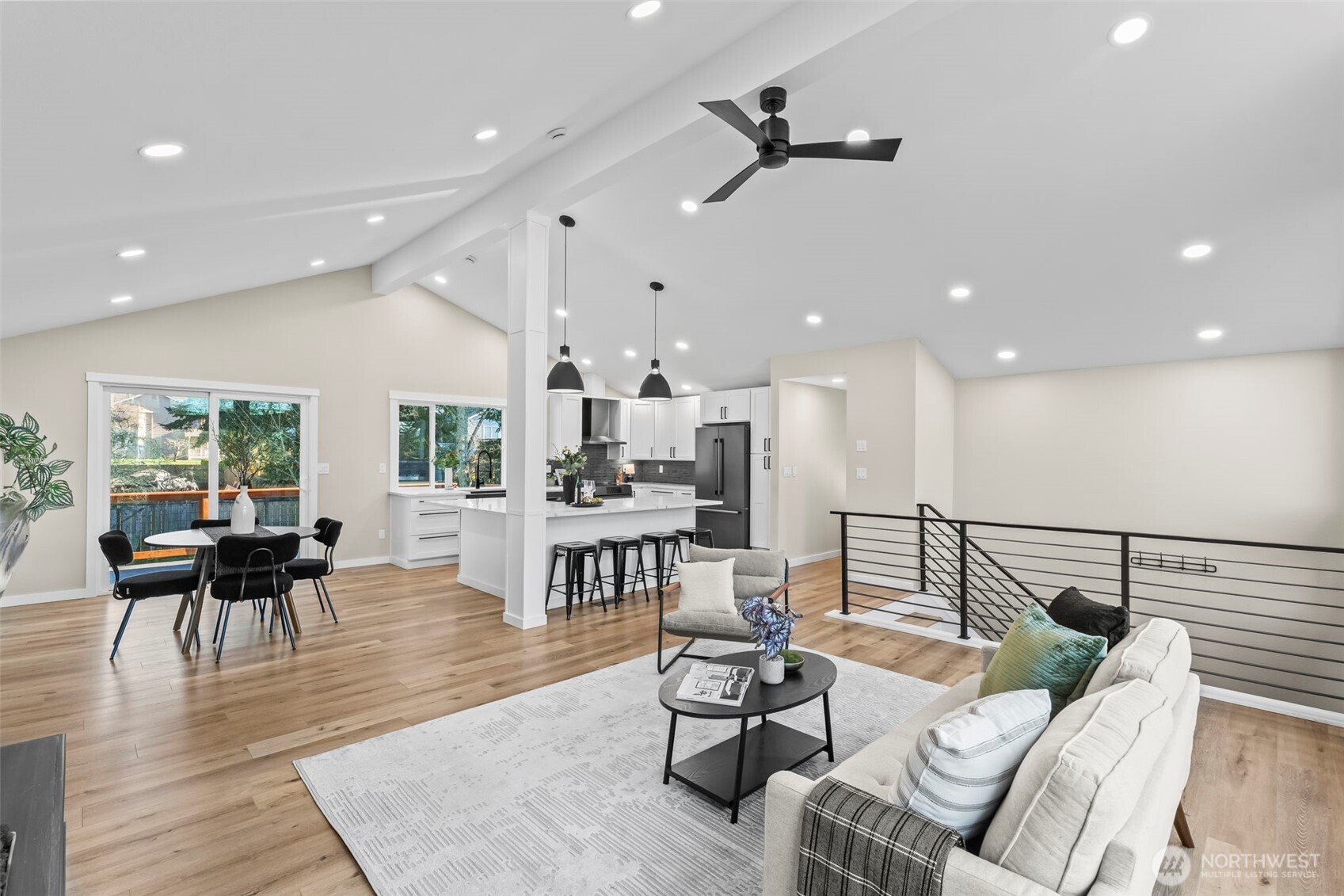 9844 Olson Road Northwest Silverdale, WA 98383 - Photo 8 of 38 a living room with furniture kitchen view and a wooden floor