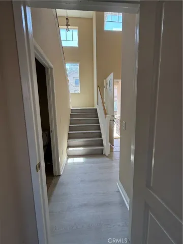 a view of a hallway with wooden floor and entryway