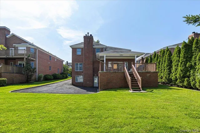 a view of a house with a yard and trees