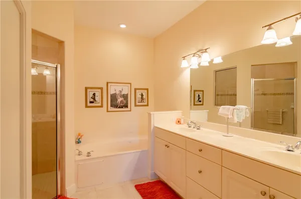 a bathroom with a double vanity sink mirror and