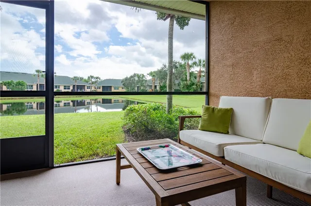 a view of a patio with couches chairs dining table and chairs next to a yard