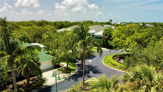 an aerial view of a house with a yard and lake view