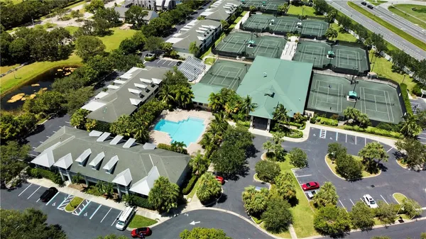 an aerial view of a house with a yard and lake view