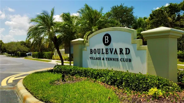 a blue sign that is next to a road