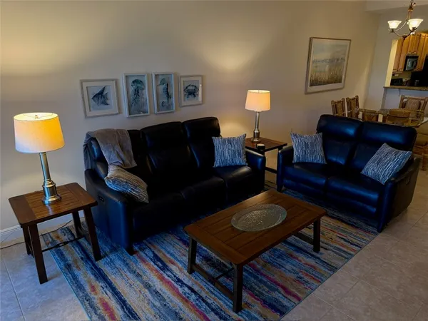 a living room with furniture a lamp and a flat screen tv