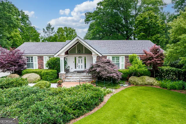 a view of a house with a yard and garden