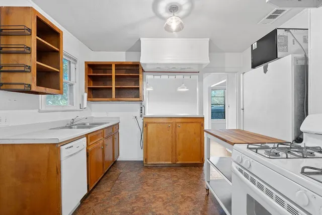a kitchen with stainless steel appliances granite countertop a stove and a refrigerator