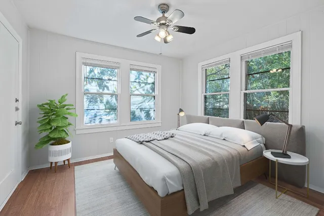 a bedroom with a bed and a chandelier