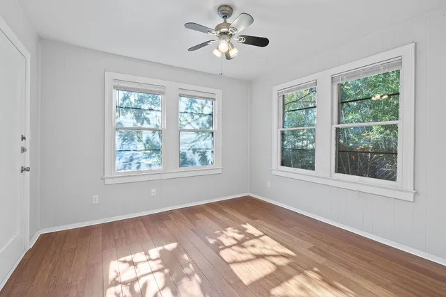 a view of a room with a window and ceiling fan