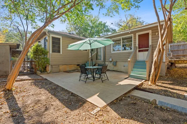 a view of a backyard with sitting area