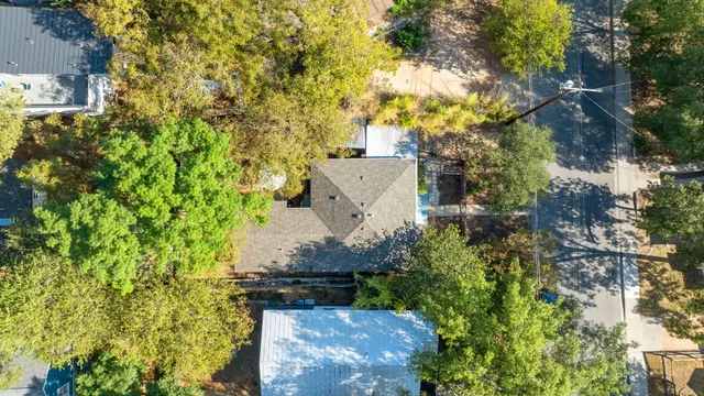 an aerial view of a house with a yard