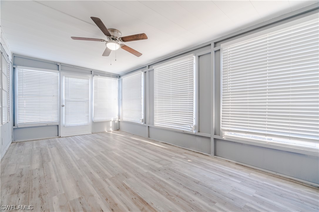 153 Cape Sable Drive Naples, FL 34104 - Photo 19 of 35 wooden floor in an empty room with a window