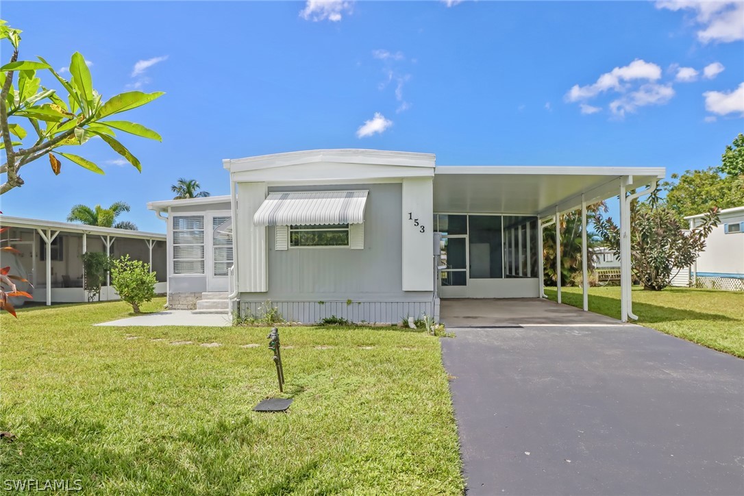 153 Cape Sable Drive Naples, FL 34104 - Photo 3 of 35 a view of a house with backyard and porch