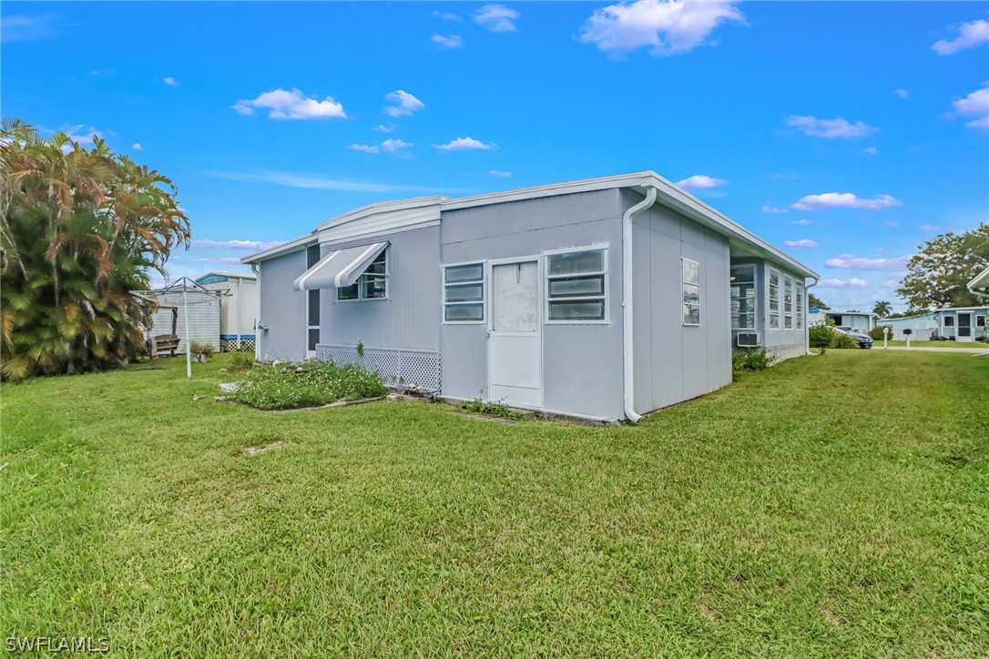 153 Cape Sable Drive Naples, FL 34104 - Photo 32 of 35 a view of a house with a yard