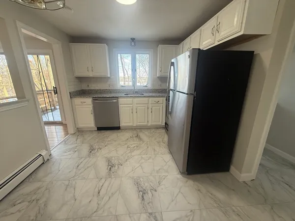 a kitchen with a refrigerator and a sink