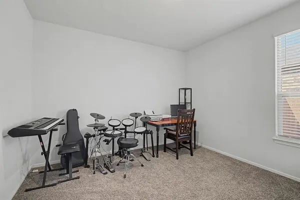 a view of a workspace with furniture and window