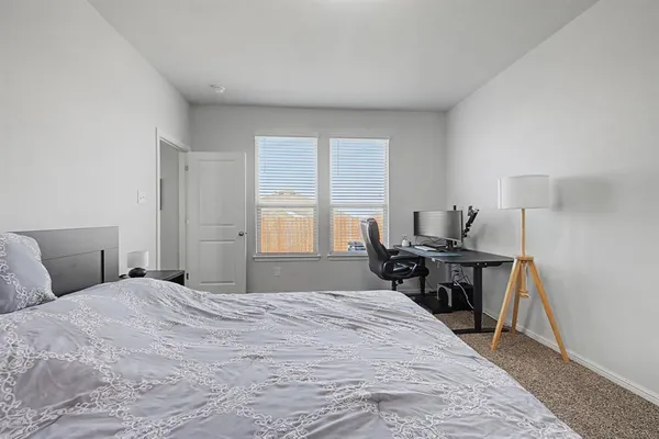 a bedroom with a bed and a table in it