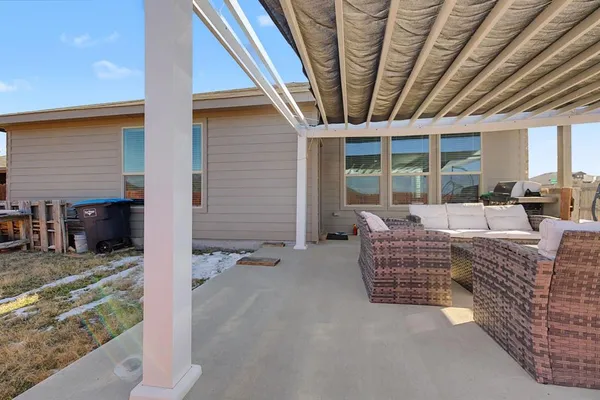 a outdoor living space with patio furniture and wooden floor
